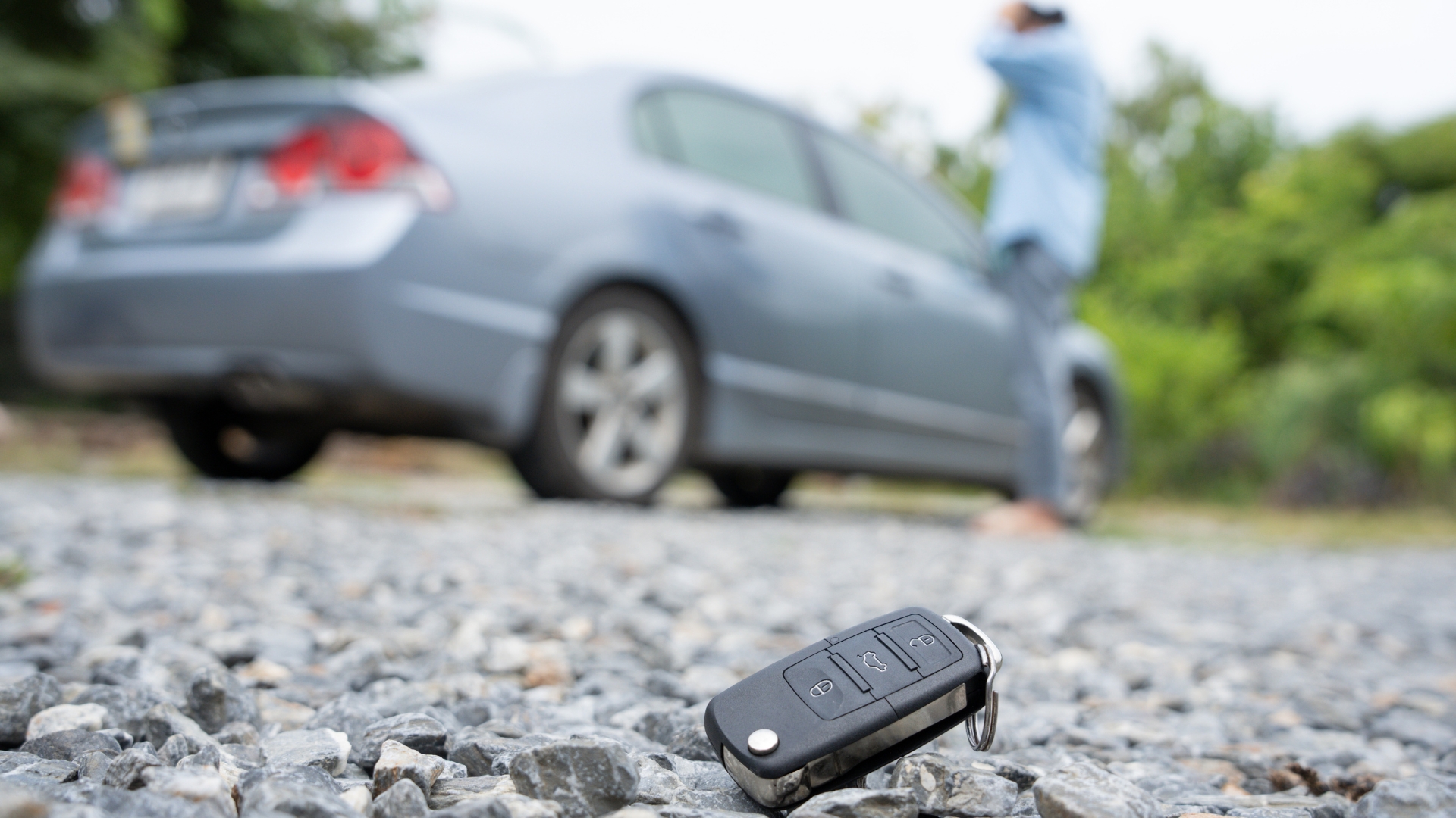 A car owner could not get into his car. In the foreground, his key fob is seen on the ground