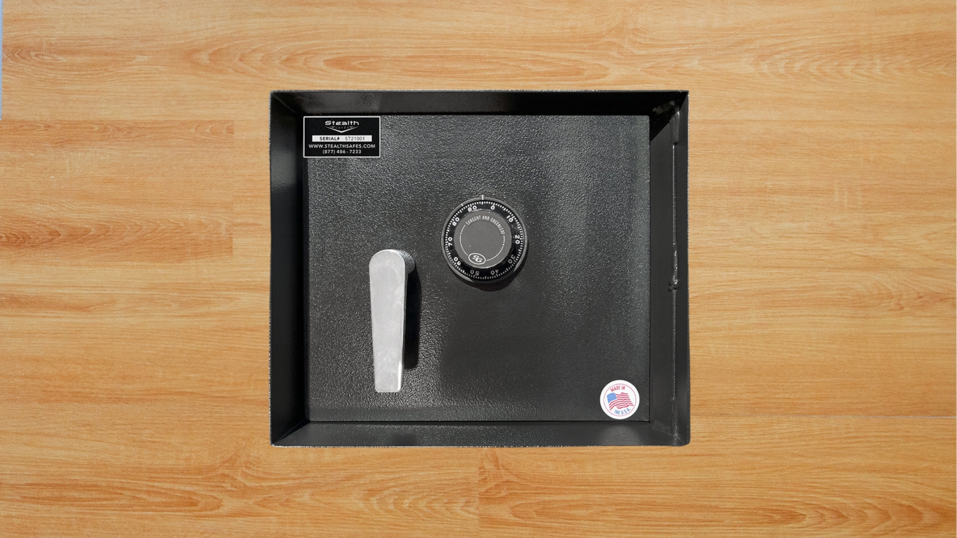 A floor safe installation on a wooden floor featuring a combination lock for secure storage.