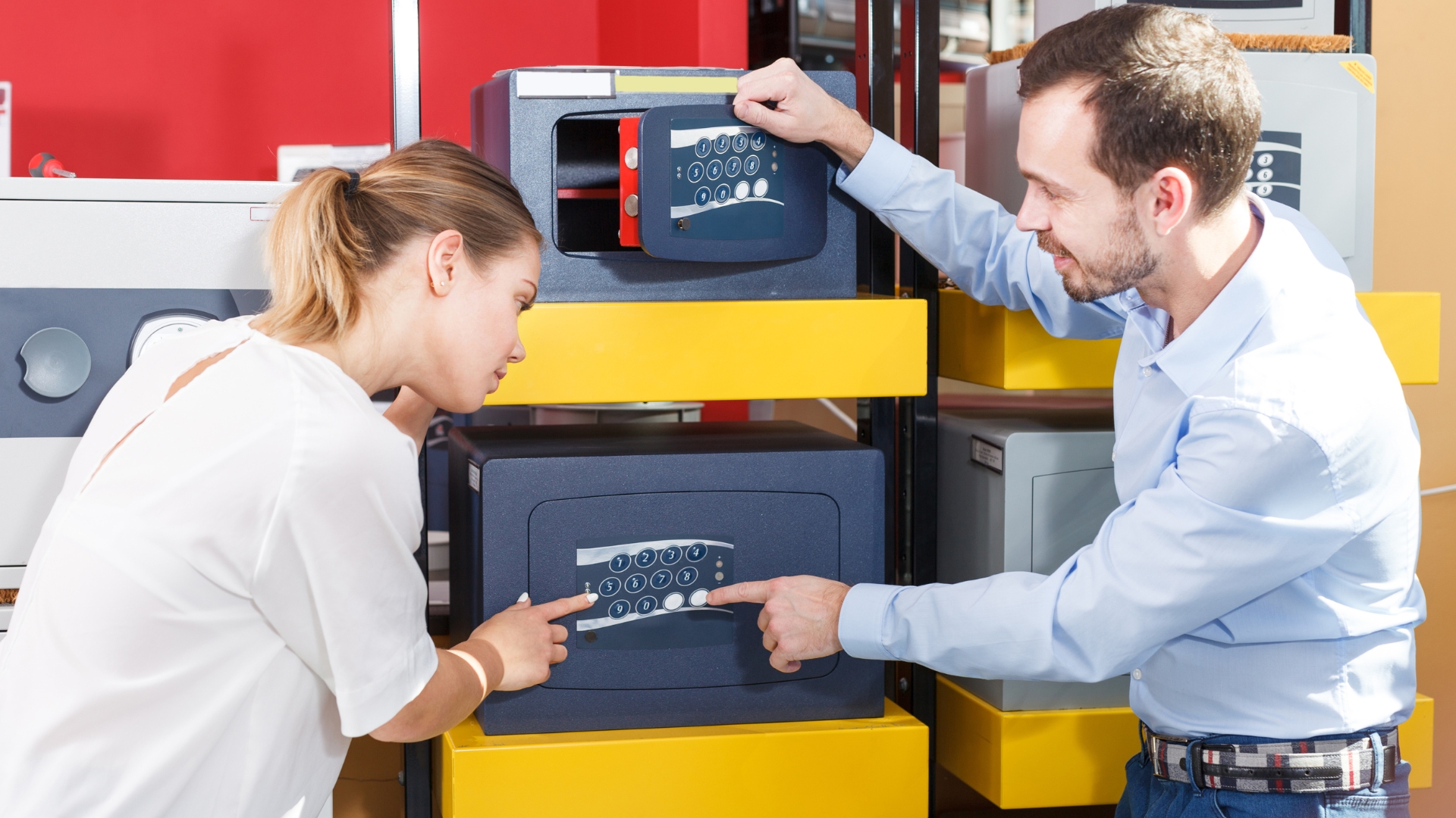 Salesperson explaining the importance of safe ratings to a customer choosing a safe.